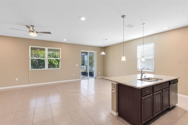 kitchen featuring light stone counters, ceiling fan, sink, decorative light fixtures, and dishwasher