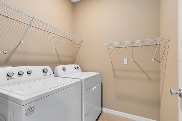 washroom with washer and clothes dryer and light tile patterned flooring