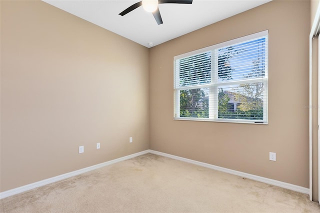 carpeted empty room featuring ceiling fan