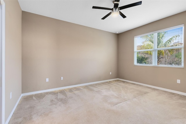 spare room with light carpet and ceiling fan