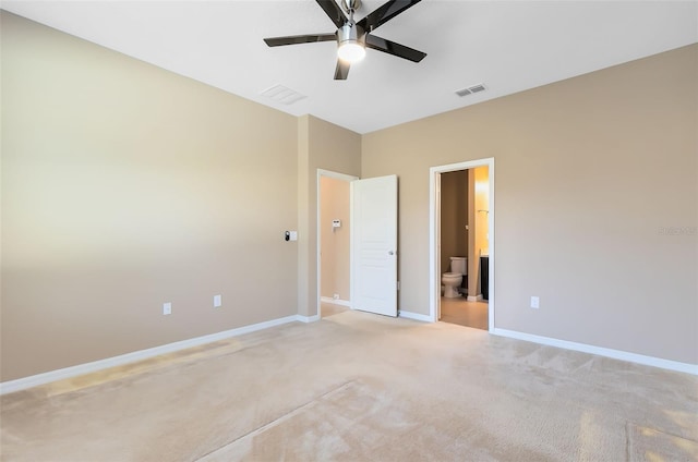 unfurnished bedroom featuring light carpet, connected bathroom, and ceiling fan