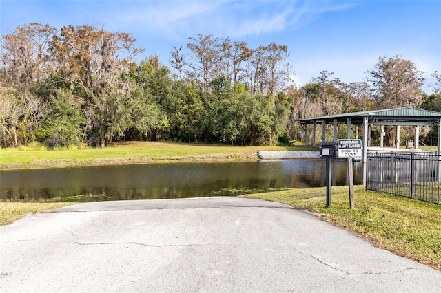 exterior space featuring a water view and a yard