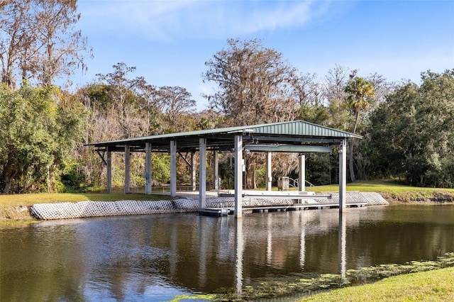 dock area featuring a water view and a lawn