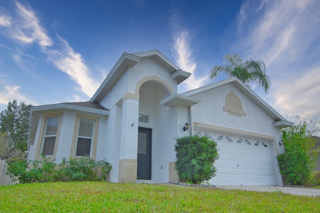 view of front of property with a garage and a front yard