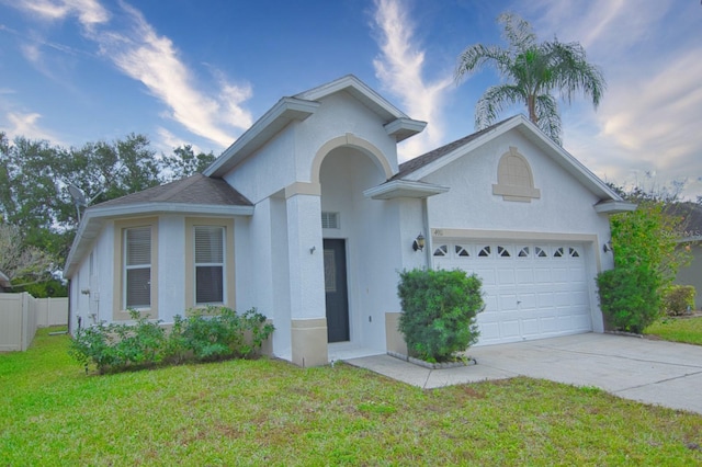 view of front of property with a front lawn and a garage