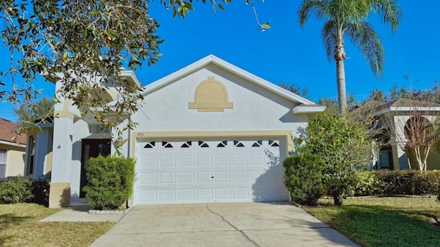 view of front of property featuring a garage and a front lawn