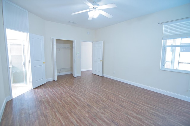 unfurnished bedroom with wood-type flooring, a closet, and ceiling fan