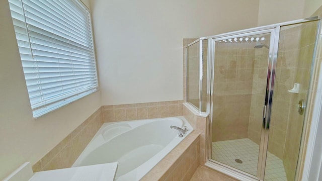 bathroom featuring plus walk in shower and tile patterned flooring