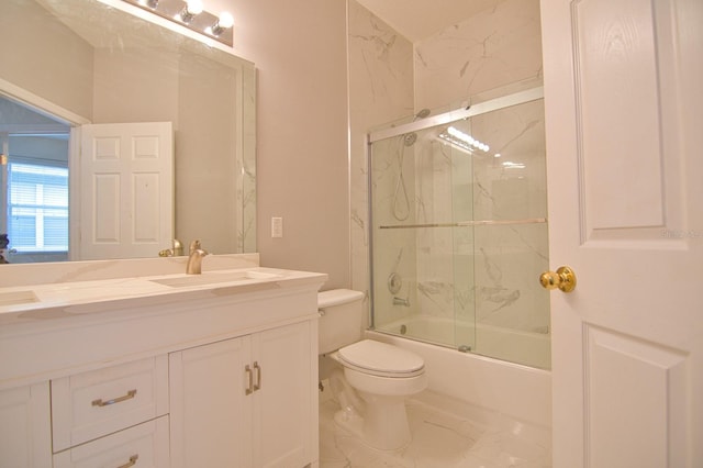 full bathroom with vanity, enclosed tub / shower combo, and toilet