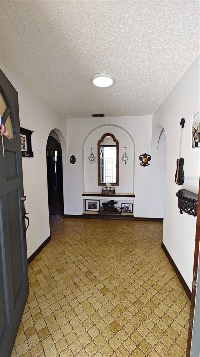 corridor with a textured ceiling