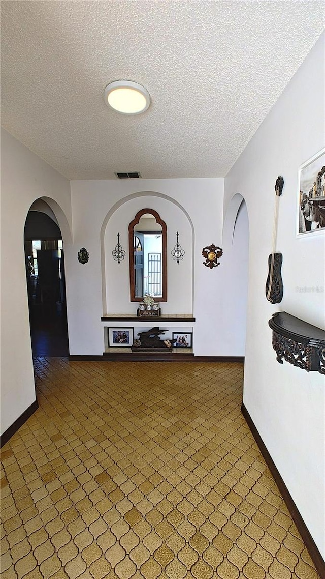 hallway with a textured ceiling