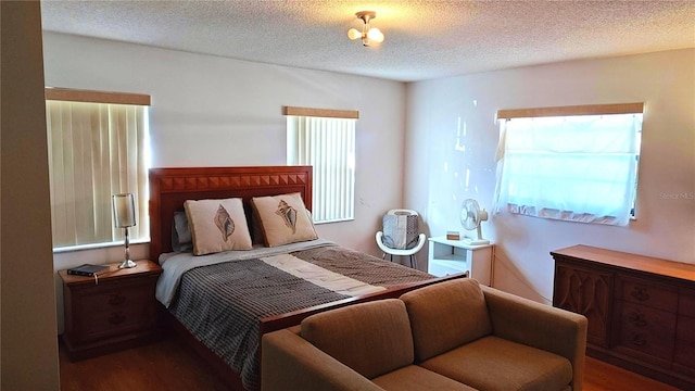 bedroom with hardwood / wood-style floors and a textured ceiling