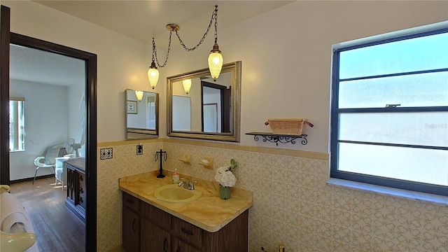 bathroom featuring vanity and tile walls