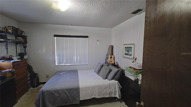 bedroom with light colored carpet and a textured ceiling