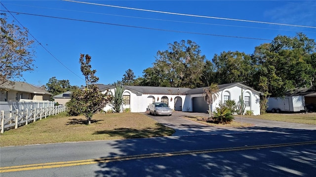 view of front facade with a front yard and a garage