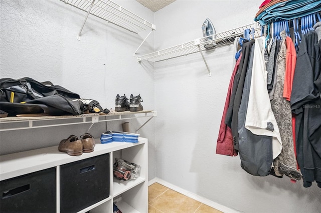 spacious closet with light tile patterned floors