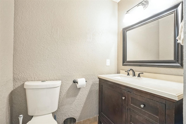 bathroom with toilet and vanity