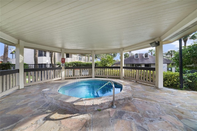 view of pool with a hot tub