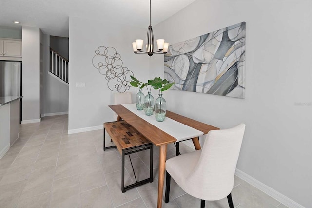 dining space with a notable chandelier and light tile patterned flooring