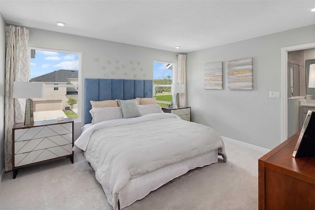 bedroom featuring light colored carpet and multiple windows