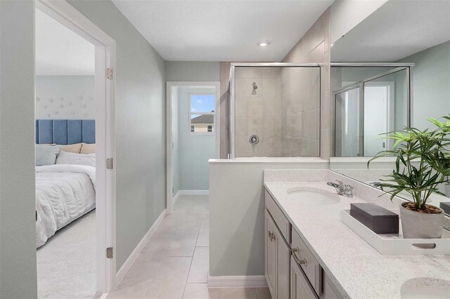 bathroom featuring vanity, tile patterned floors, and a shower with door