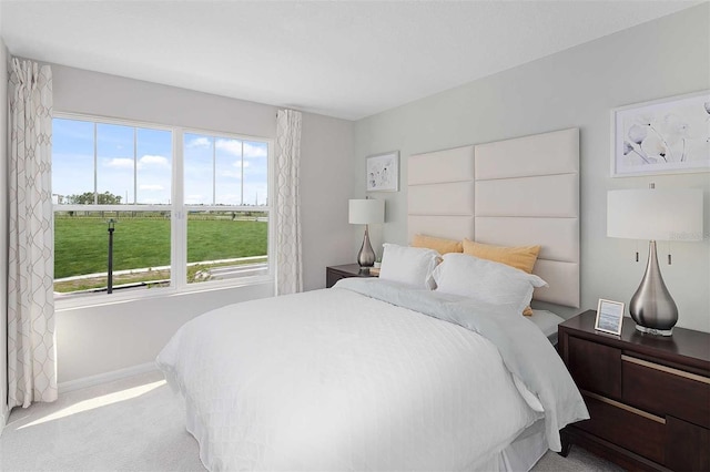 carpeted bedroom featuring multiple windows