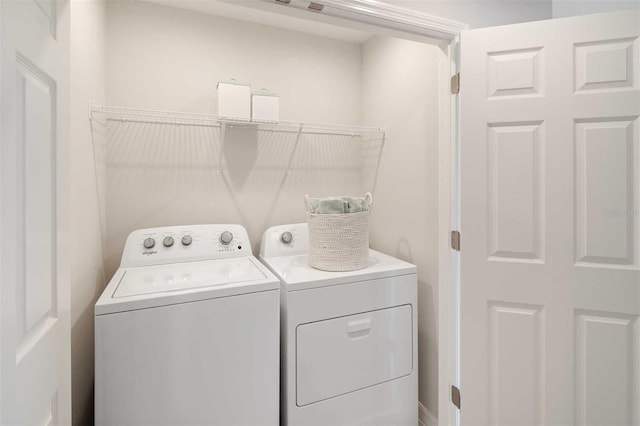 clothes washing area with washer and dryer