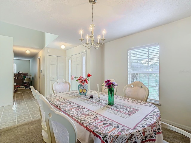 dining space featuring a chandelier and light colored carpet