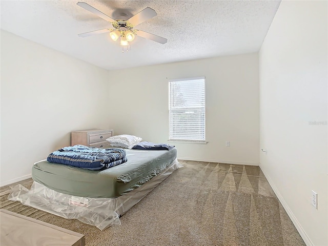 bedroom with carpet, a textured ceiling, and ceiling fan