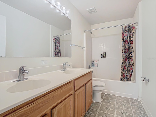 full bathroom with tile patterned flooring, shower / bath combo with shower curtain, vanity, and toilet