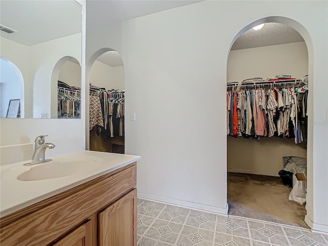 bathroom with tile patterned flooring and vanity