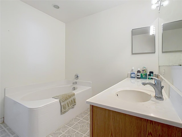 bathroom with tile patterned flooring, vanity, and a bathing tub