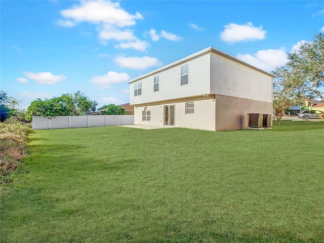 rear view of house with a yard and a patio