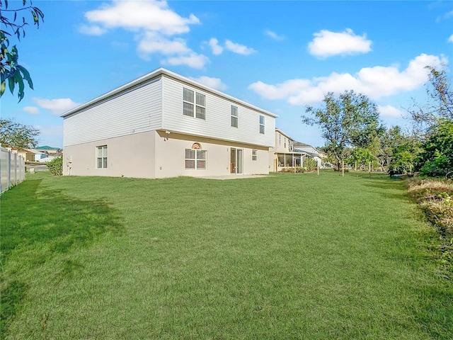 rear view of property with a patio area and a lawn