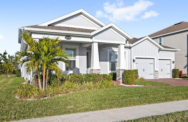 craftsman-style home featuring a garage and a front yard