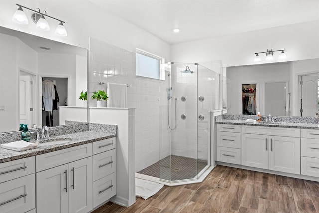 bathroom with vanity and tiled shower