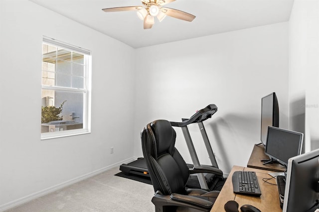 carpeted office featuring ceiling fan