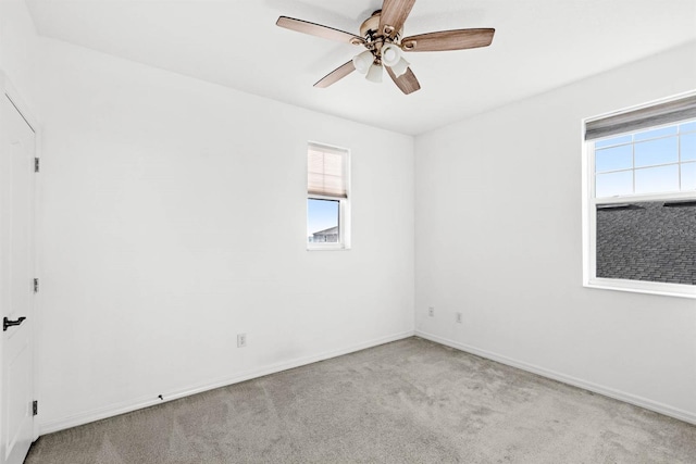 spare room with light carpet and ceiling fan