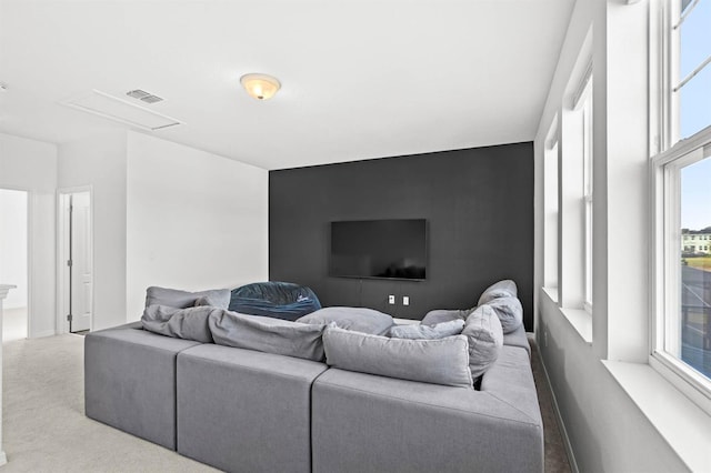 carpeted living room featuring plenty of natural light