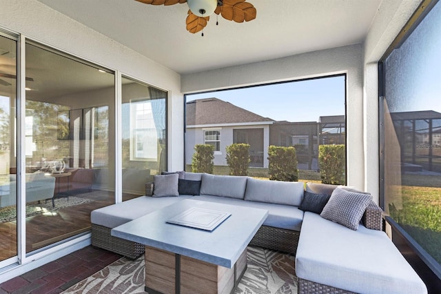 sunroom / solarium featuring ceiling fan and a wealth of natural light