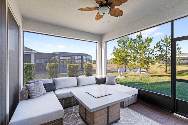 sunroom / solarium with plenty of natural light and ceiling fan