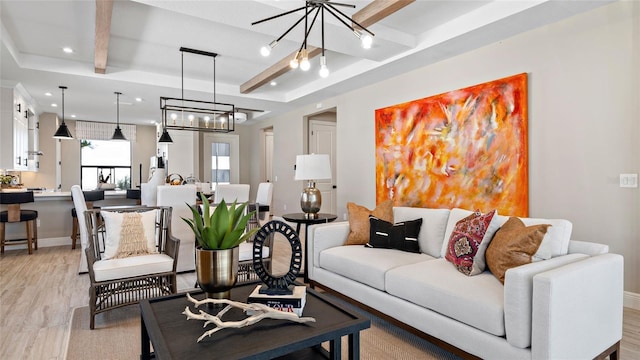 living room featuring a chandelier, light hardwood / wood-style floors, and beam ceiling