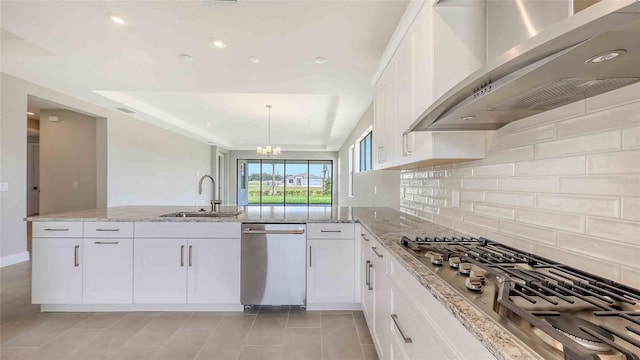 14370 Hammock Oak St, Parrish, FL 34219 - kitchen featuring wall chimney exhaust hood, appliances with stainless steel finishes, a sink, light stone counters, and recessed lighting