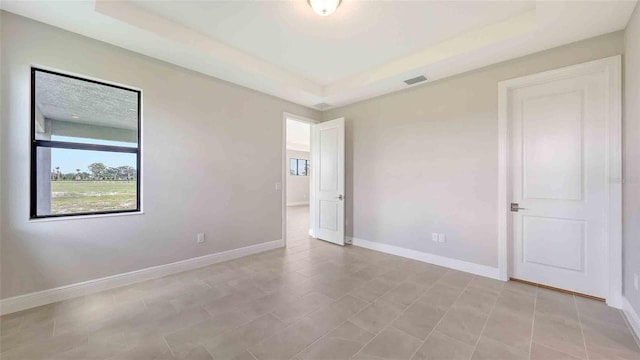 14370 Hammock Oak St, Parrish, FL 34219 - spare room featuring a raised ceiling and baseboards