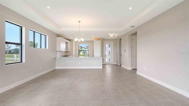 14370 Hammock Oak St, Parrish, FL 34219 - unfurnished living room with a raised ceiling, a chandelier, recessed lighting, and baseboards