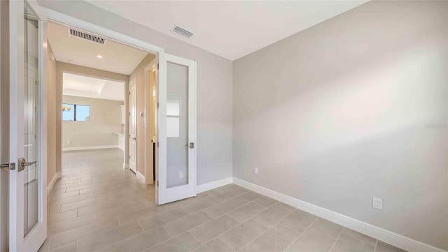 14370 Hammock Oak St, Parrish, FL 34219 - unfurnished room with french doors, baseboards, and light tile patterned flooring