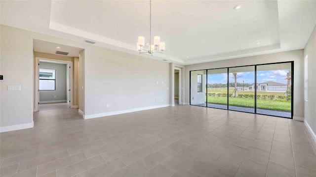 14370 Hammock Oak St, Parrish, FL 34219 - spare room with a tray ceiling, plenty of natural light, a chandelier, and recessed lighting