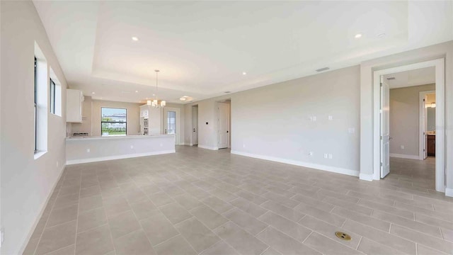 14370 Hammock Oak St, Parrish, FL 34219 - unfurnished living room featuring a chandelier, recessed lighting, a tray ceiling, and baseboards