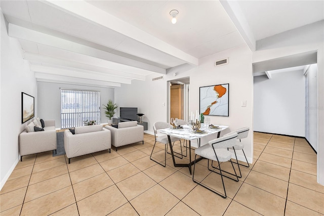 tiled dining room with beamed ceiling