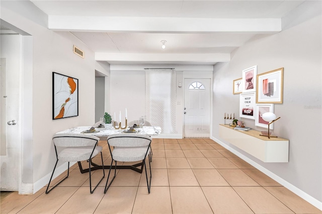 tiled dining space with beam ceiling